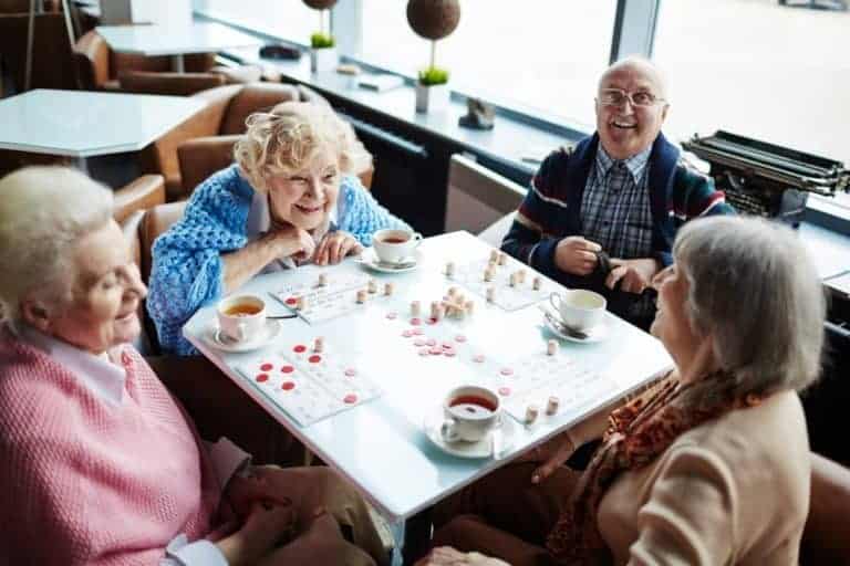 elderly people are playing a board game