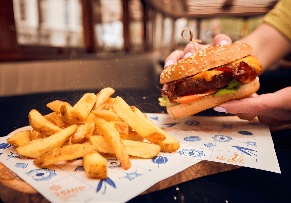 Burger with fries on a board on a boat
