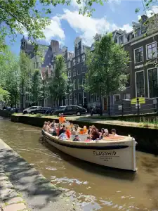 Green Marine sloop sailing with group on canal