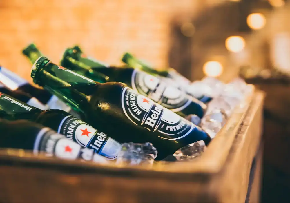Heineken beer bottles in a cooler with ice