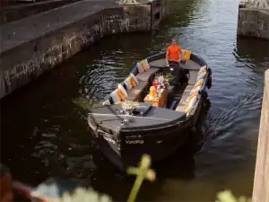 Sloep vording varend met schipper op grachten FI